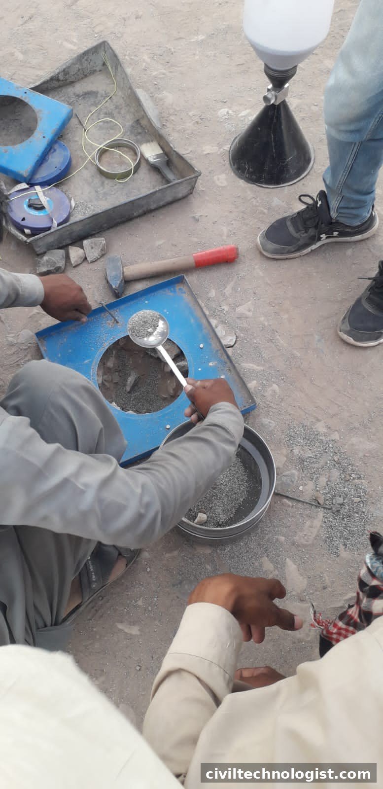Sand cone apparatus filling an excavated hole with calibrated sand during a field density test