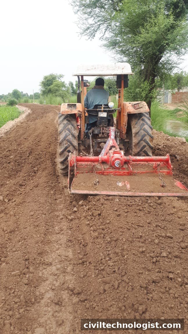 Tractor with rotavator pulverizing road subgrade soil in Pakistan