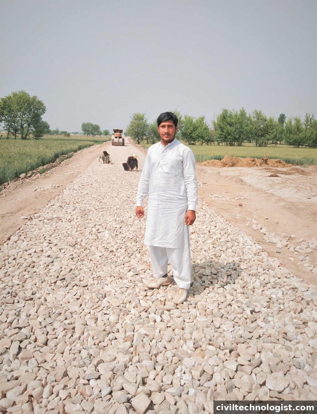 Water bound macadam layer with coarse aggregate spread before asphalt laying